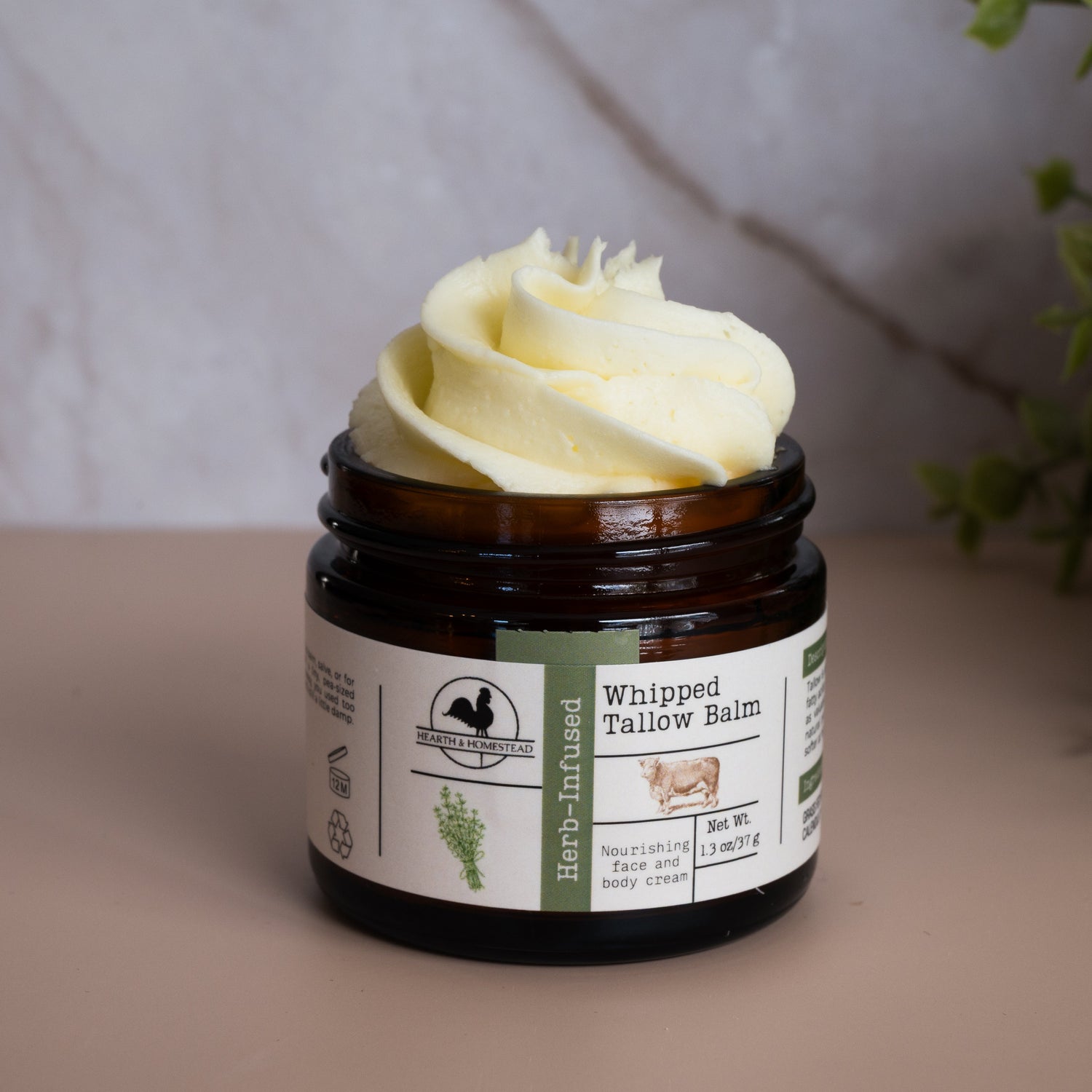 Jar of whipped balm with a decorative top on a neutral background